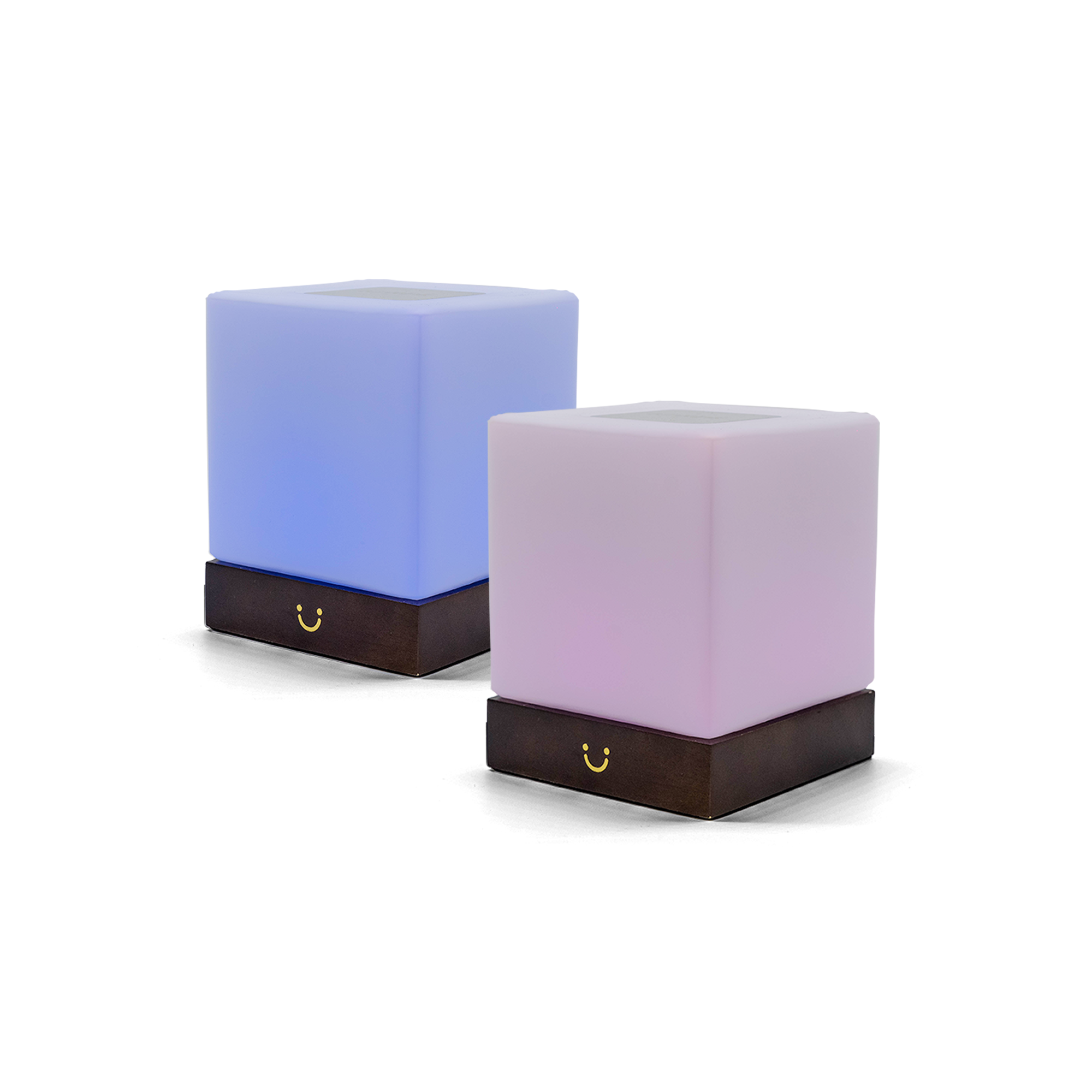 Two cube lamps glowing in blue and pink with dark wood bases.