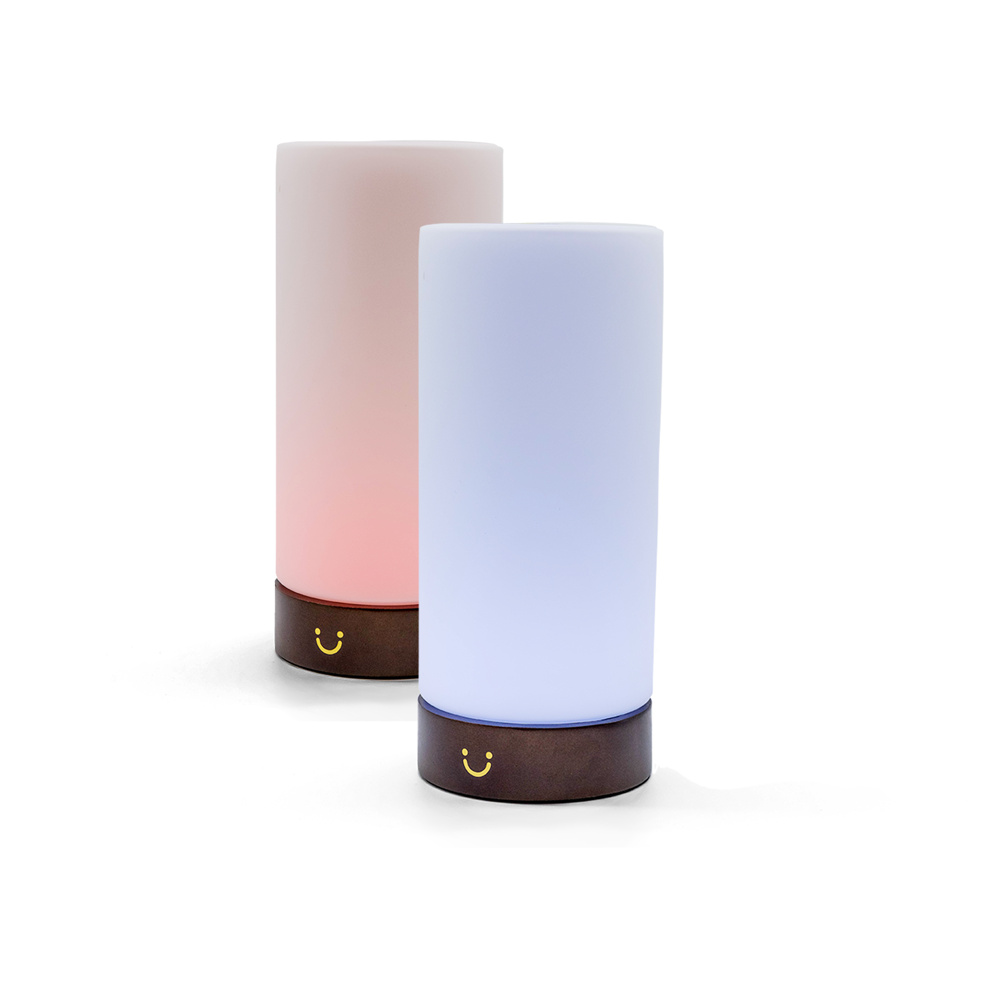 Two cylindrical lamps with gradient lighting—one pink, one blue—on dark wood bases.